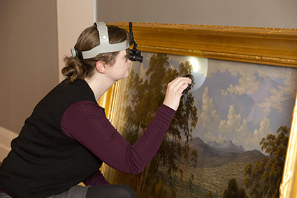 Jennifer O’Connell, Senior Conservator (Painting), condition checking a painting prior to installation in the National Picture exhibition