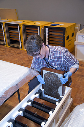 Nikki King Smith, Senior Conservator (Objects), unpacking and condition checking works for the National Picture exhibition