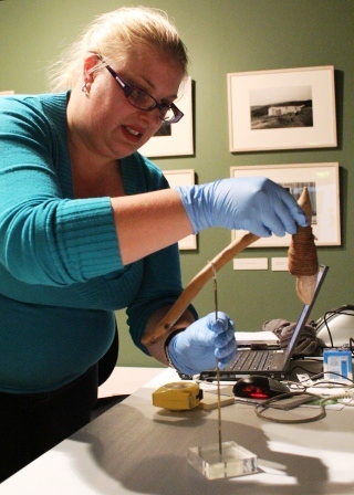 Phlippa Cox prepares an adze from the Indigenous Cultures Gallery for storage